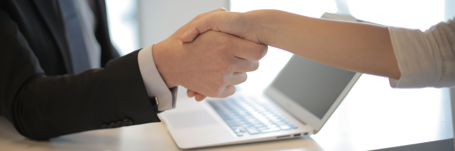 People giving each other a handshake.